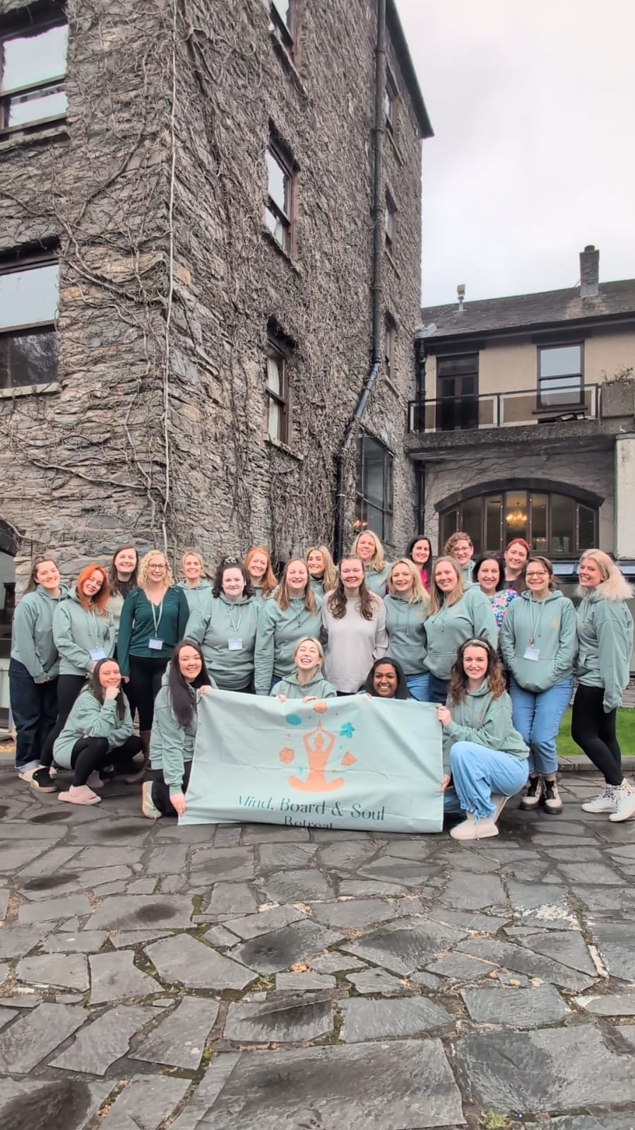 Women holding the Mind Board and Soul retreat banner